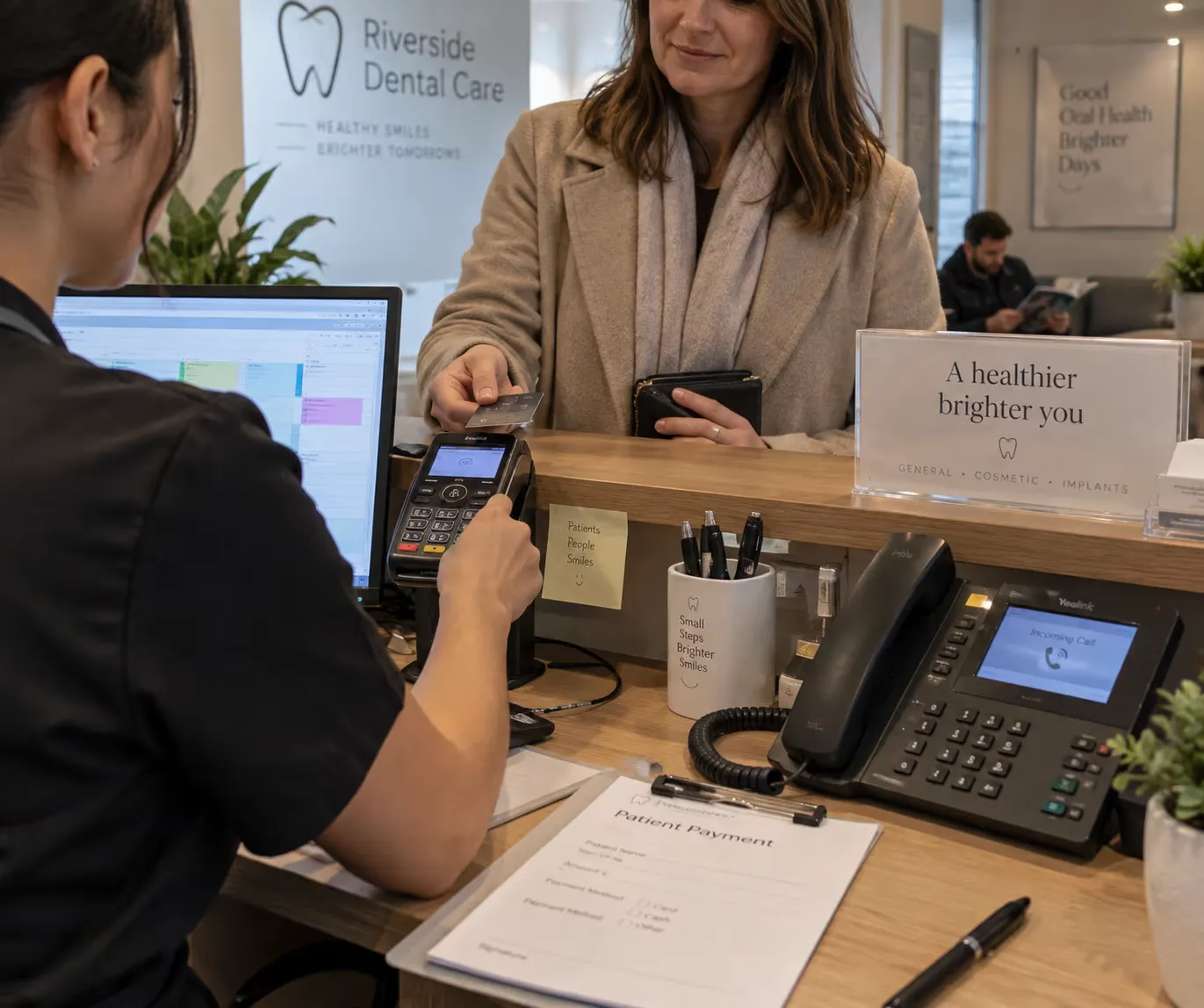 A busy dental receptionist missing a call from a patient
